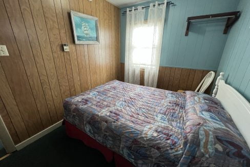 a bed sitting in a bedroom next to a window.