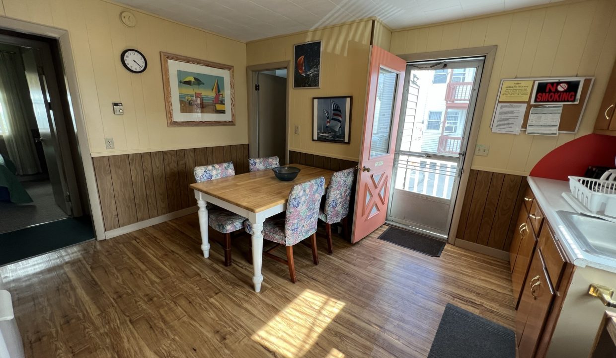 a dining room with a table and chairs.