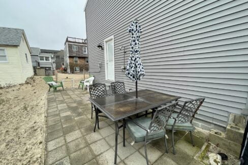 a patio with a table and chairs and an umbrella.