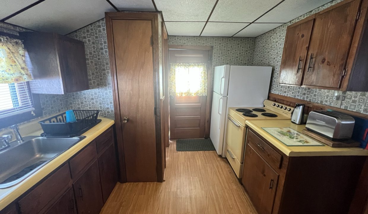 a kitchen with a sink, stove and refrigerator.