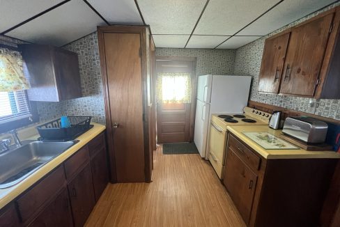 a kitchen with a sink, stove and refrigerator.