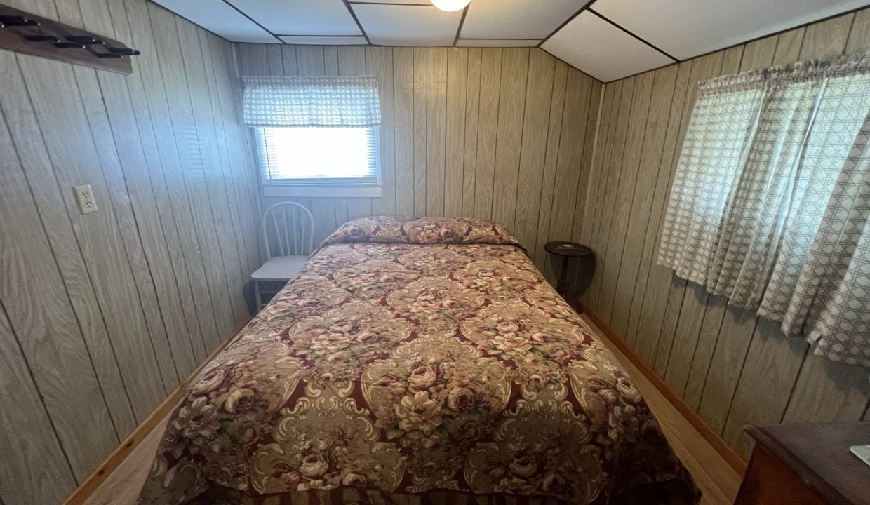 a bed sitting in a bedroom next to a window.