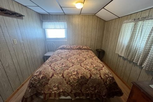 a bed sitting in a bedroom next to a window.