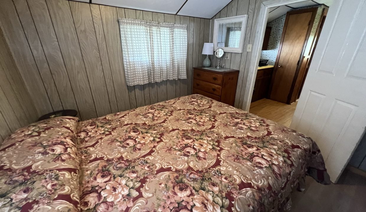 a bedroom with a bed and a dresser.