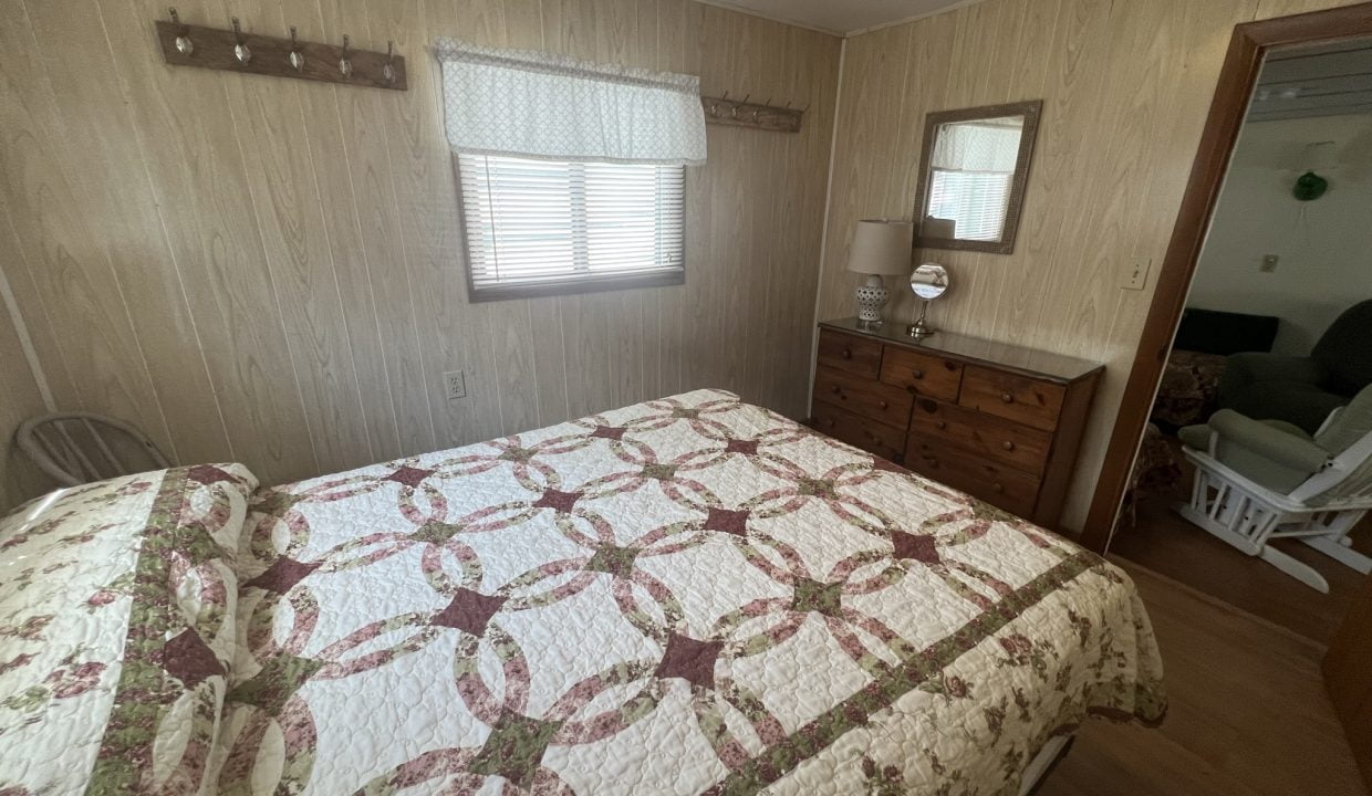 a bed sitting in a bedroom next to a dresser.