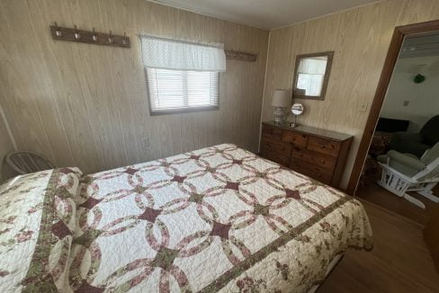 a bed sitting in a bedroom next to a dresser.