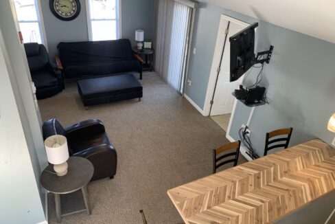 a living room with a couch, chair and television.