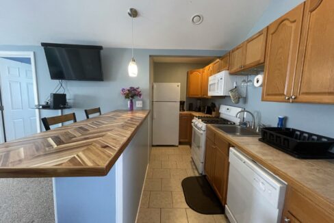 a kitchen with a counter top and a stove top oven.