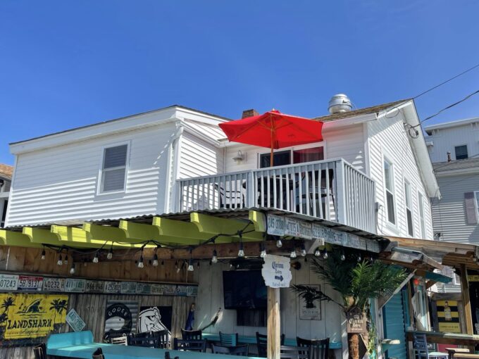 a white house with a red umbrella over it.