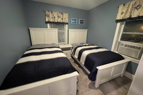 a couple of beds sitting next to each other in a bedroom.