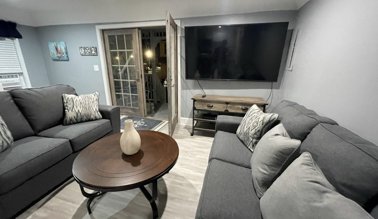 a living room filled with furniture and a flat screen tv.