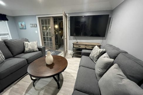 a living room filled with furniture and a flat screen tv.