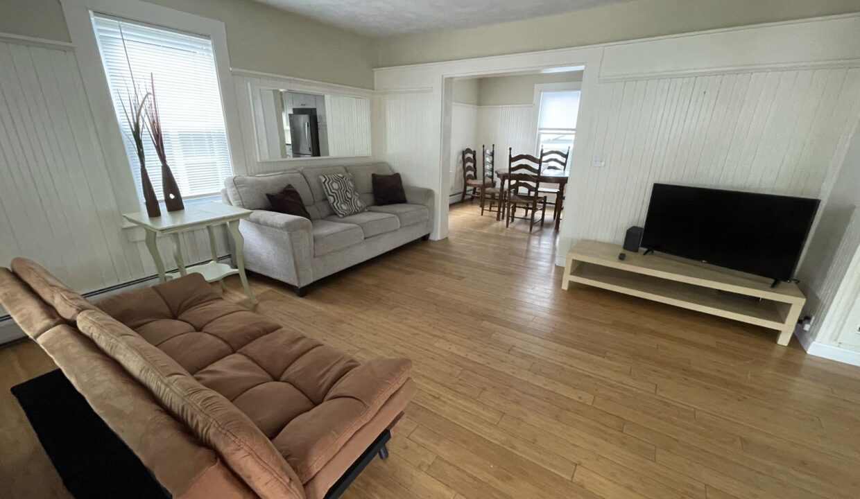 a living room filled with furniture and a flat screen tv.