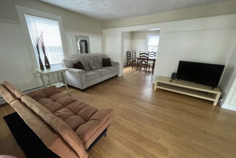 a living room filled with furniture and a flat screen tv.