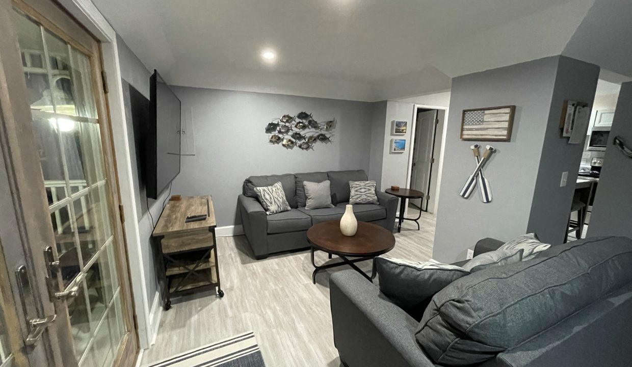 a living room filled with furniture and a flat screen tv.