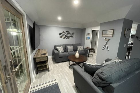 a living room filled with furniture and a flat screen tv.