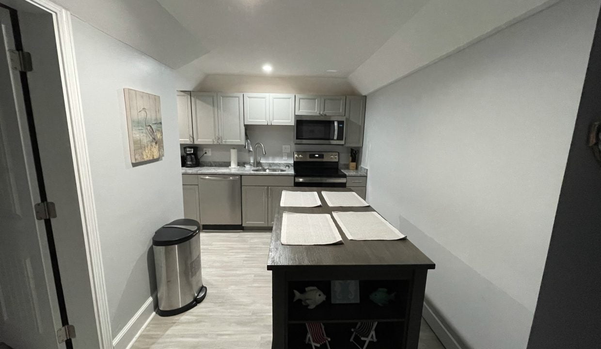 a kitchen with stainless steel appliances and white walls.