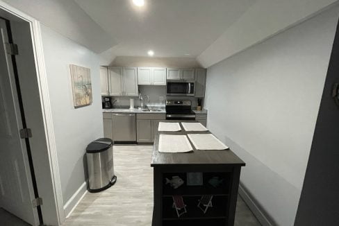 a kitchen with stainless steel appliances and white walls.