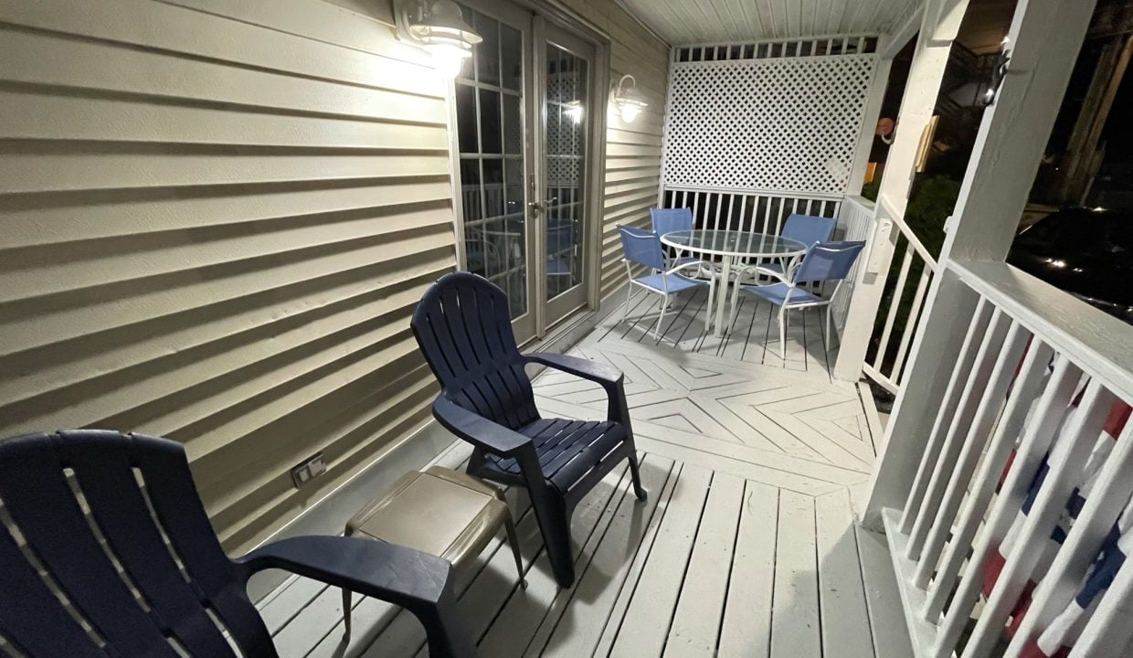 a couple of chairs that are on a porch.