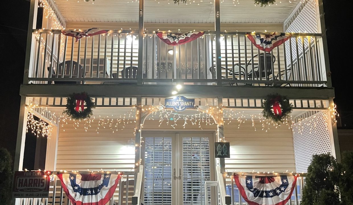 a house decorated for christmas with wreaths and lights.