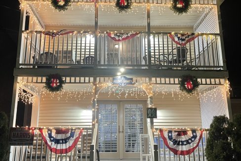 a house decorated for christmas with wreaths and lights.