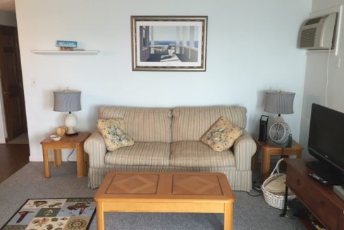 a living room filled with furniture and a flat screen tv.