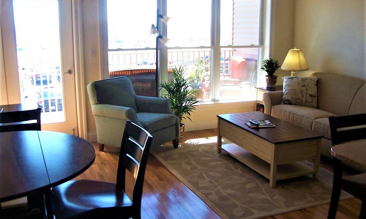 a living room filled with furniture and a wooden table.