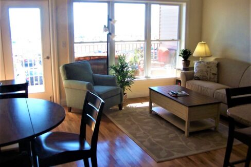 a living room filled with furniture and a wooden table.