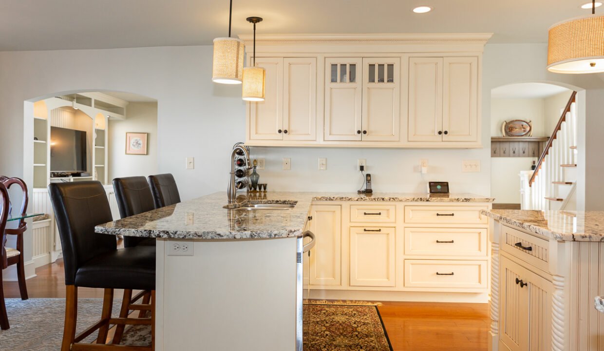 a kitchen with a center island with a marble counter top.