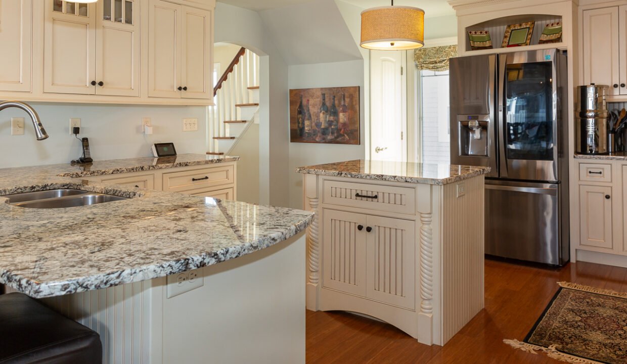 a kitchen with a refrigerator and a sink.