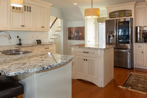 a kitchen with a refrigerator and a sink.