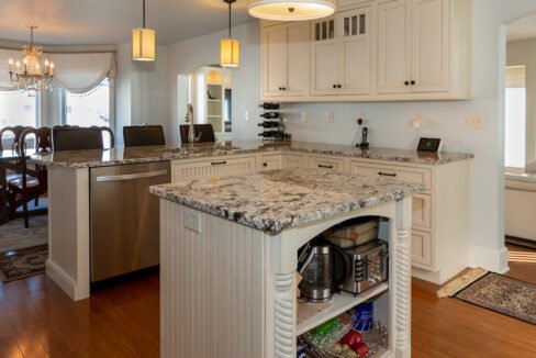 a kitchen with a center island with a marble top.