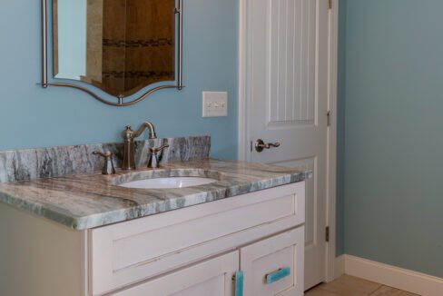 a bathroom with a double sink and a mirror.