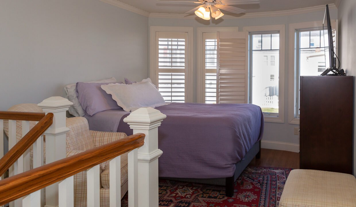 a bedroom with a bed and a chair in it.