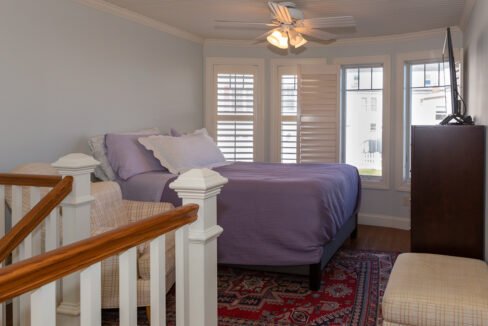 a bedroom with a bed and a chair in it.