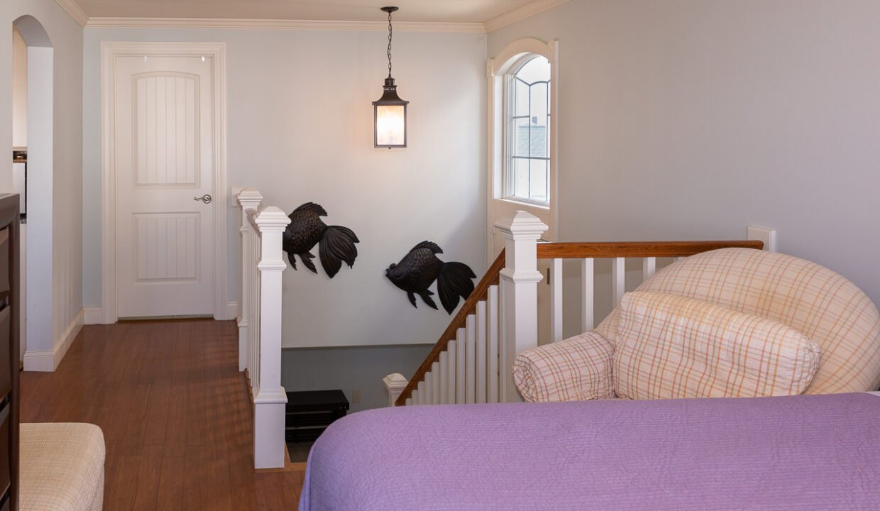 a bedroom with a bed and a purple comforter.