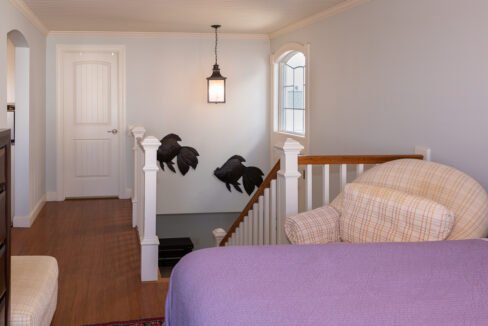 a bedroom with a bed and a purple comforter.