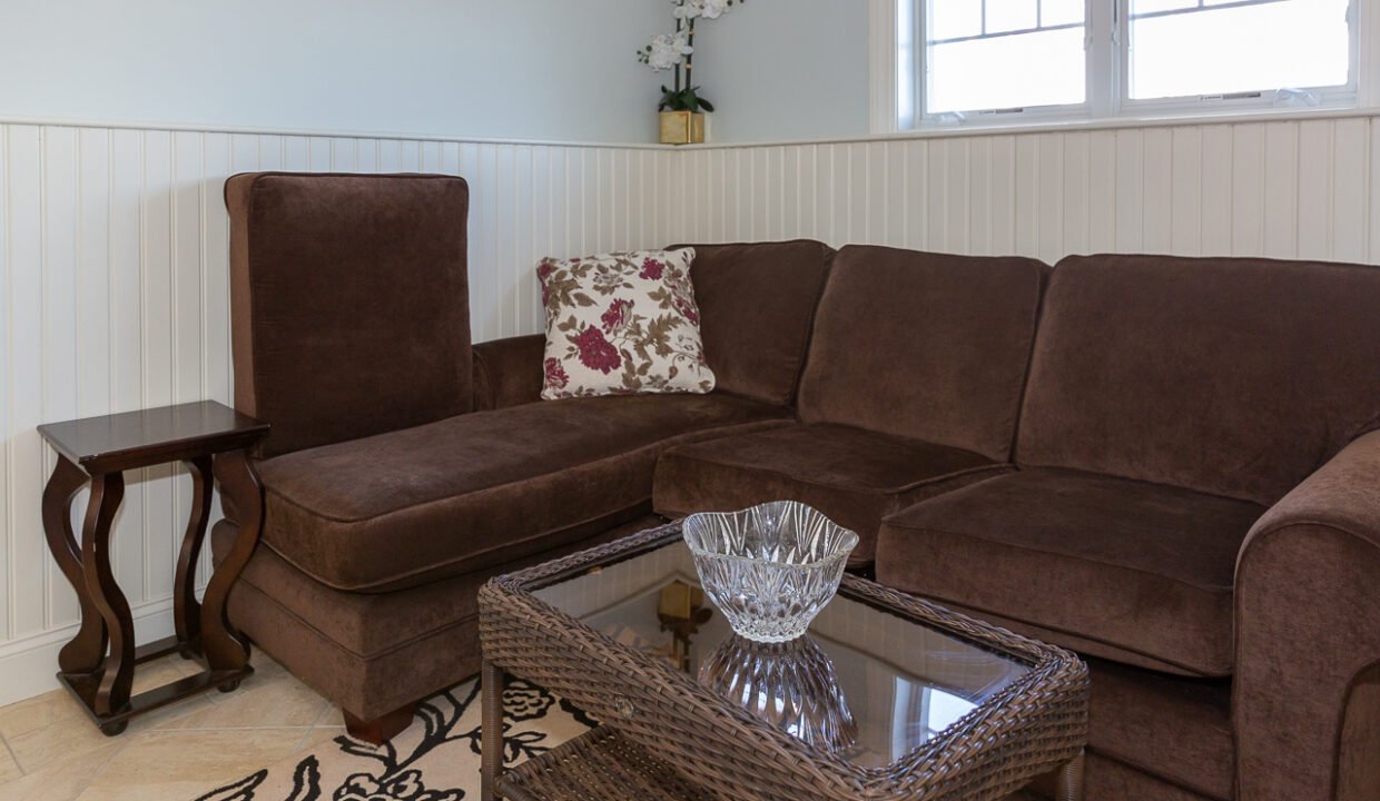 a living room with a brown couch and a table.