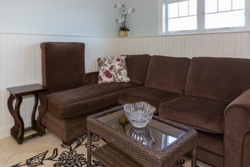 a living room with a brown couch and a table.