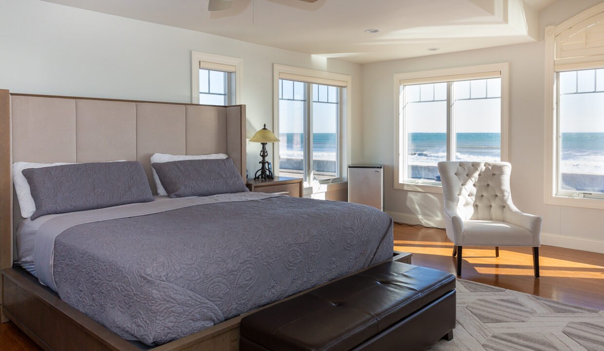 a bedroom with a large bed and a large window.