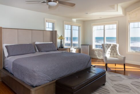 a bedroom with a large bed and a large window.