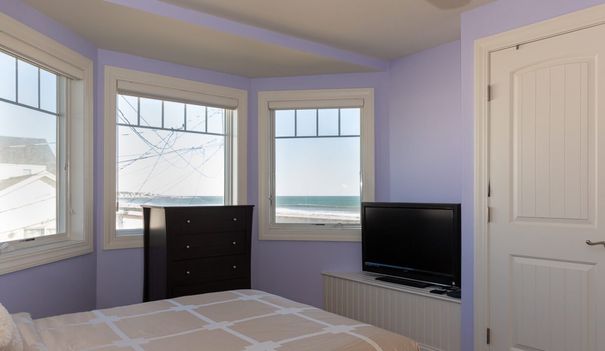 a bedroom with a bed and a flat screen tv.