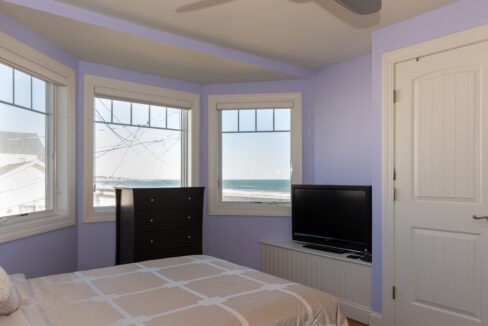 a bedroom with a bed and a flat screen tv.