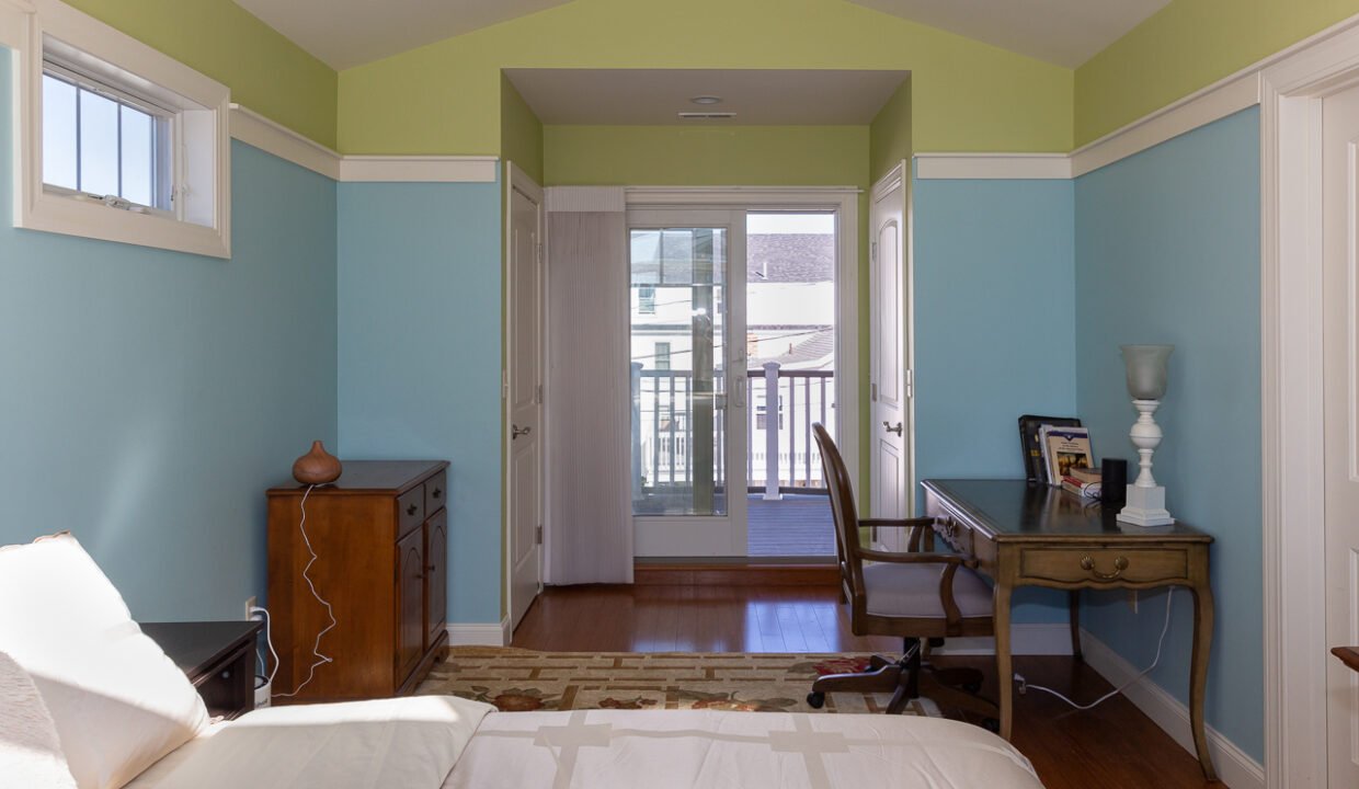 a bedroom with a bed and a desk in it.