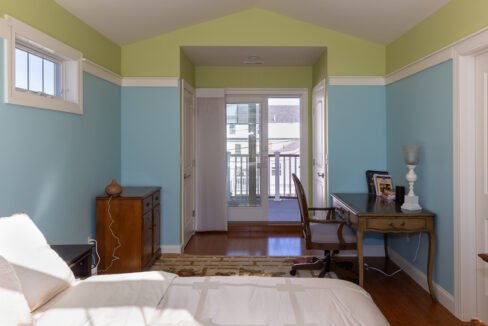 a bedroom with a bed and a desk in it.