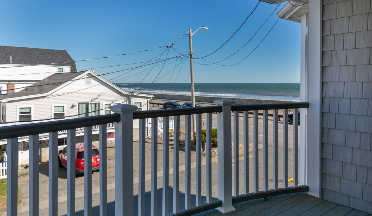 a balcony with a view of the ocean.