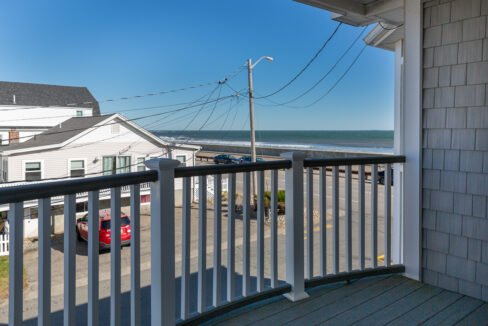 a balcony with a view of the ocean.