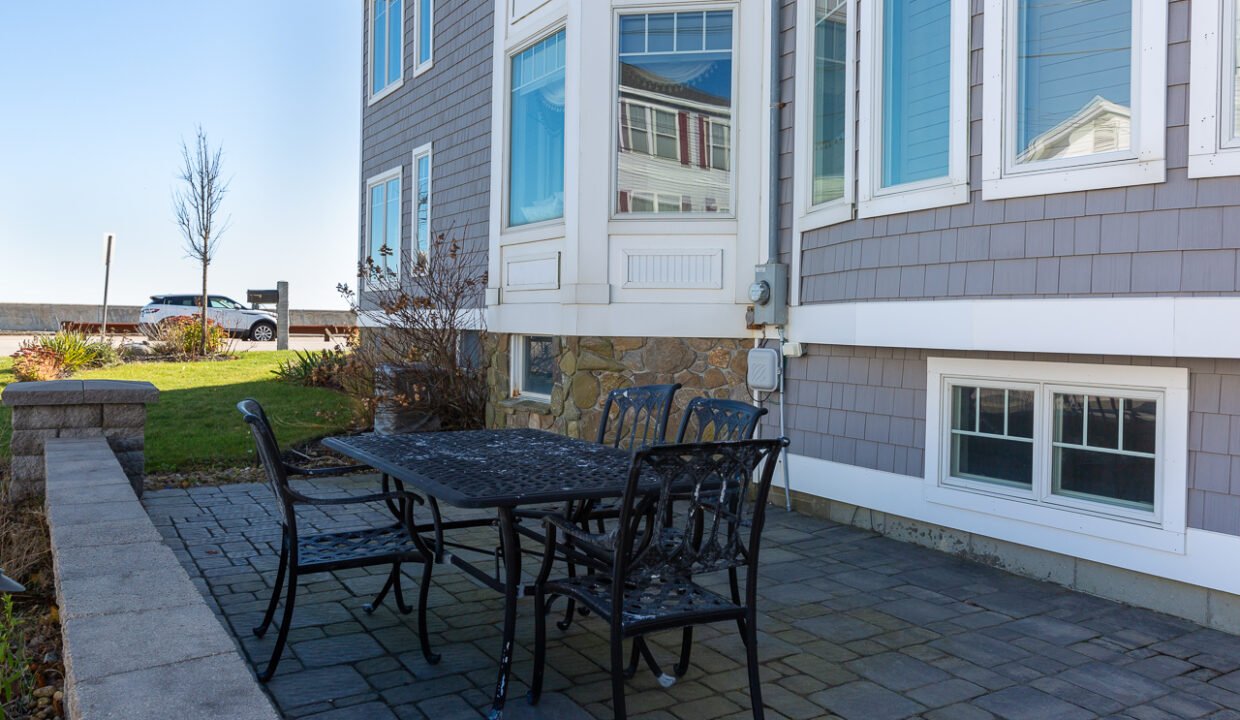 a table and chairs outside of a house.