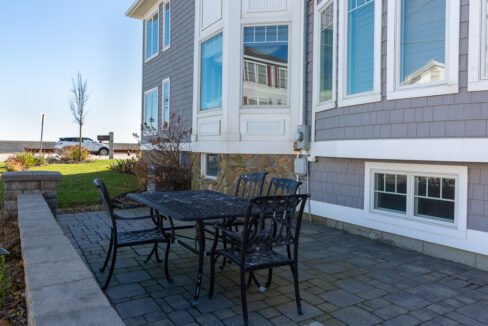 a table and chairs outside of a house.