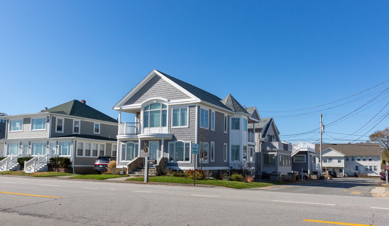 a row of houses sitting on the side of a road.